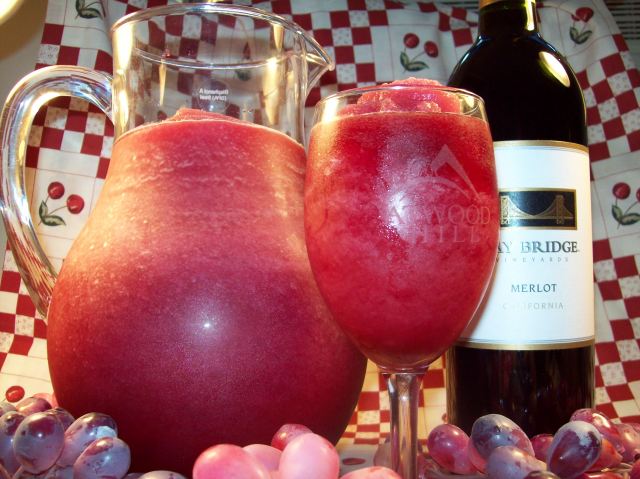 picture of a pitcher and glass of wine slushie and a bottle of wine