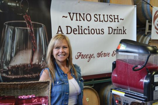 picture of a girl at a booth selling Vino Slush Wine Slushie Mixes