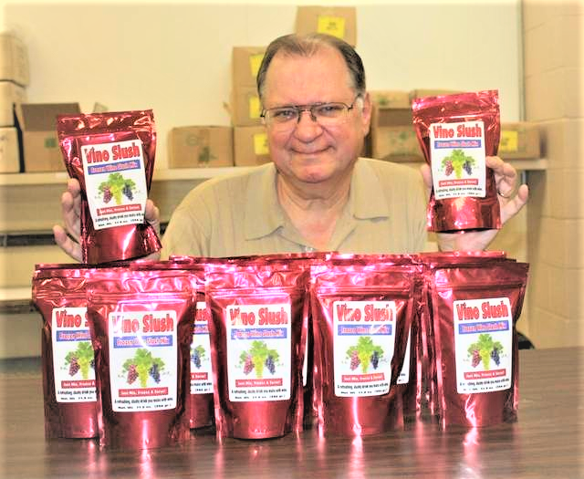 picture of man holding pouches of Vino Slush Wine and Cocktail Slushie Mixes